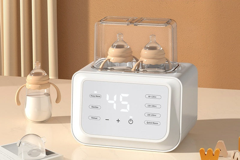 White automatic dual baby bottle warmer with digital display, two bottles inside, and a separate bottle on the side.