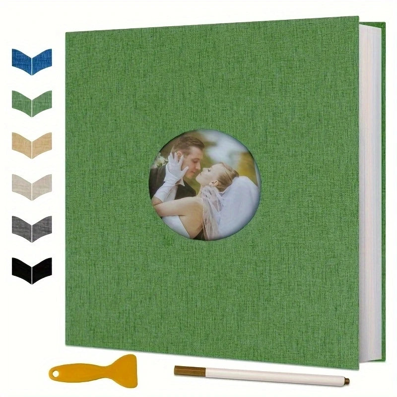 Green linen photo album with a circular cover window, including a marker and spatula.