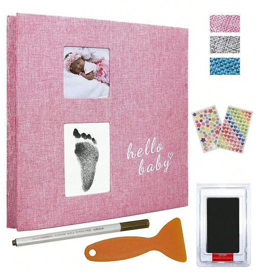 Pink linen baby photo album with footprint kit, metallic pen, and decorative stickers.