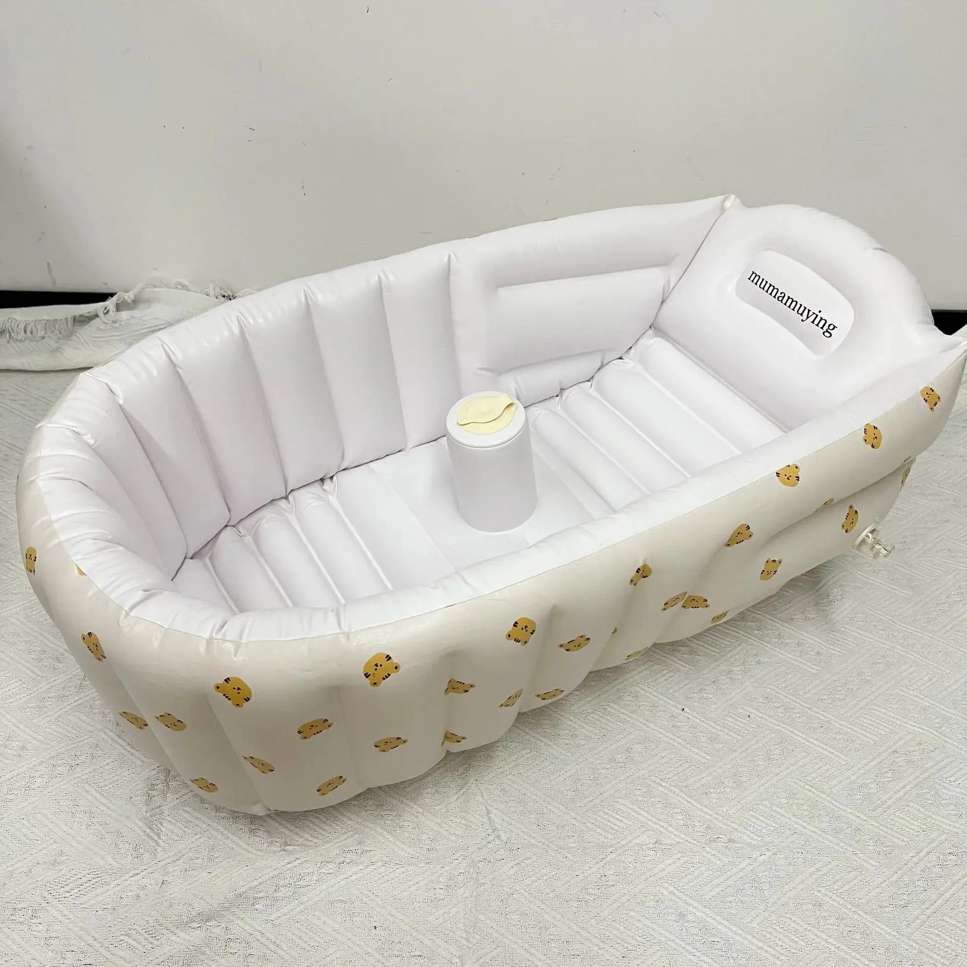 White inflatable baby bathtub with built-in pump, featuring a cute yellow animal print.