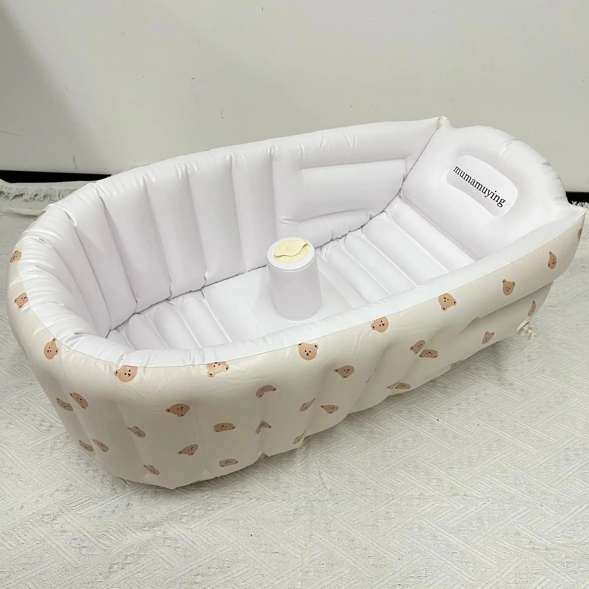 White inflatable baby bathtub with built-in pump and cute bear print, made of soft PVC.