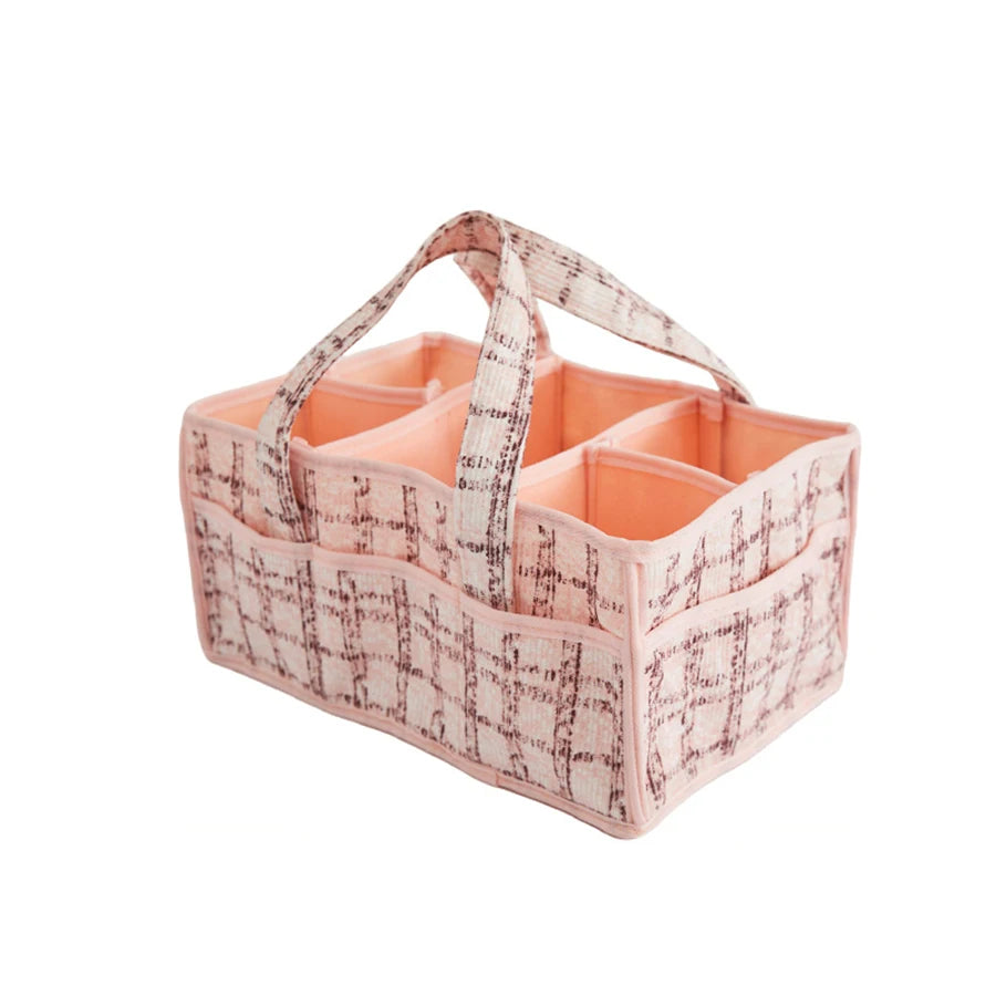 Pink plaid portable baby diaper caddy with multiple compartments and soft fabric handles.