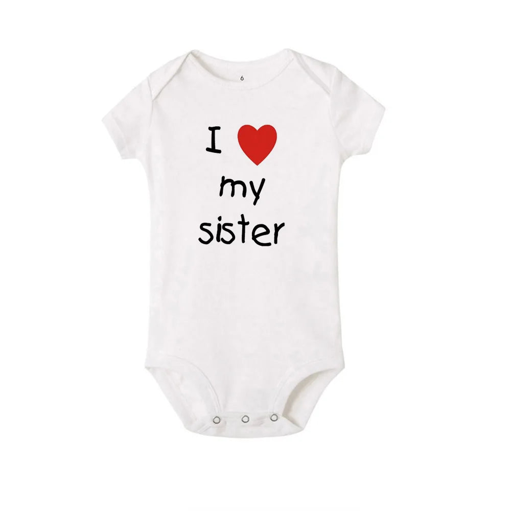 White short-sleeve baby romper with "I love my sister" print, round neck, and snap closure.