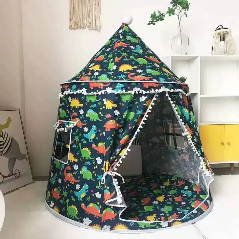 Dark blue cotton play tent for kids with colorful dinosaur print, castle design, and white pom-pom trim.