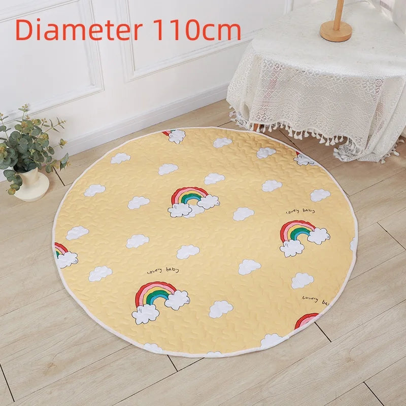 Yellow round cotton play mat with rainbows and clouds, 110cm diameter, on a wooden floor.