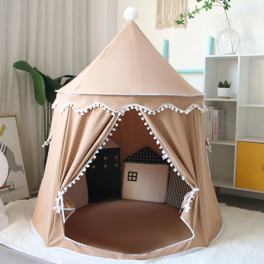 Beige cotton play tent for kids, castle design with white pom-pom trim and top, perfect for indoor play.