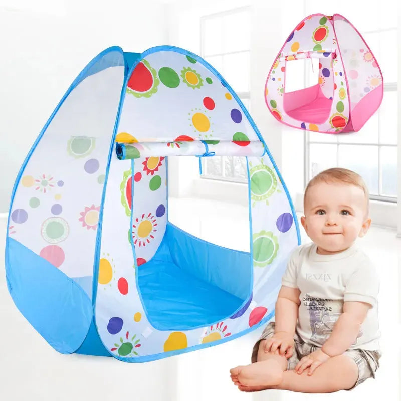 Colorful pop-up play tent with sun and polka dot design, blue base, and a baby sitting nearby.
