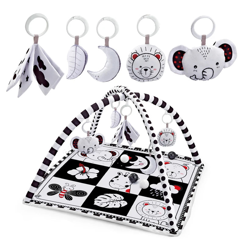 Black and white baby activity gym with arch, soft animal toys, and sensory mat.