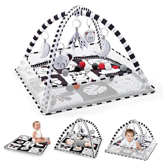 Black and white baby activity gym with arch, hanging animal toys, and soft playmat.