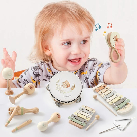 Toddler playing with a Montessori wooden musical instrument set, including a tambourine, maracas, xylophones, and a triangle.