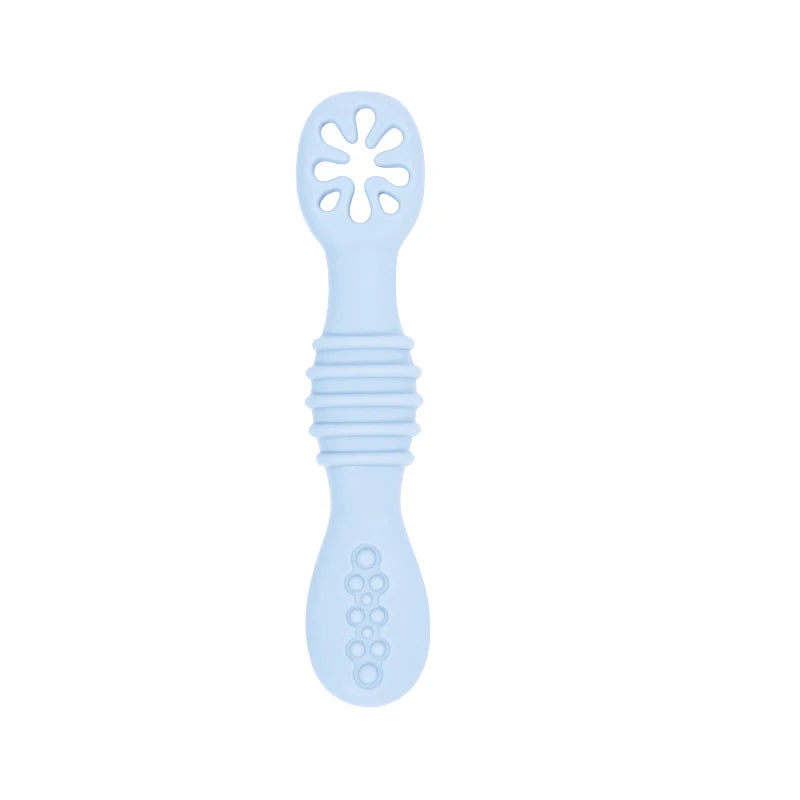 Soft blue silicone baby training spoon with textured handle and flower-shaped feeder.