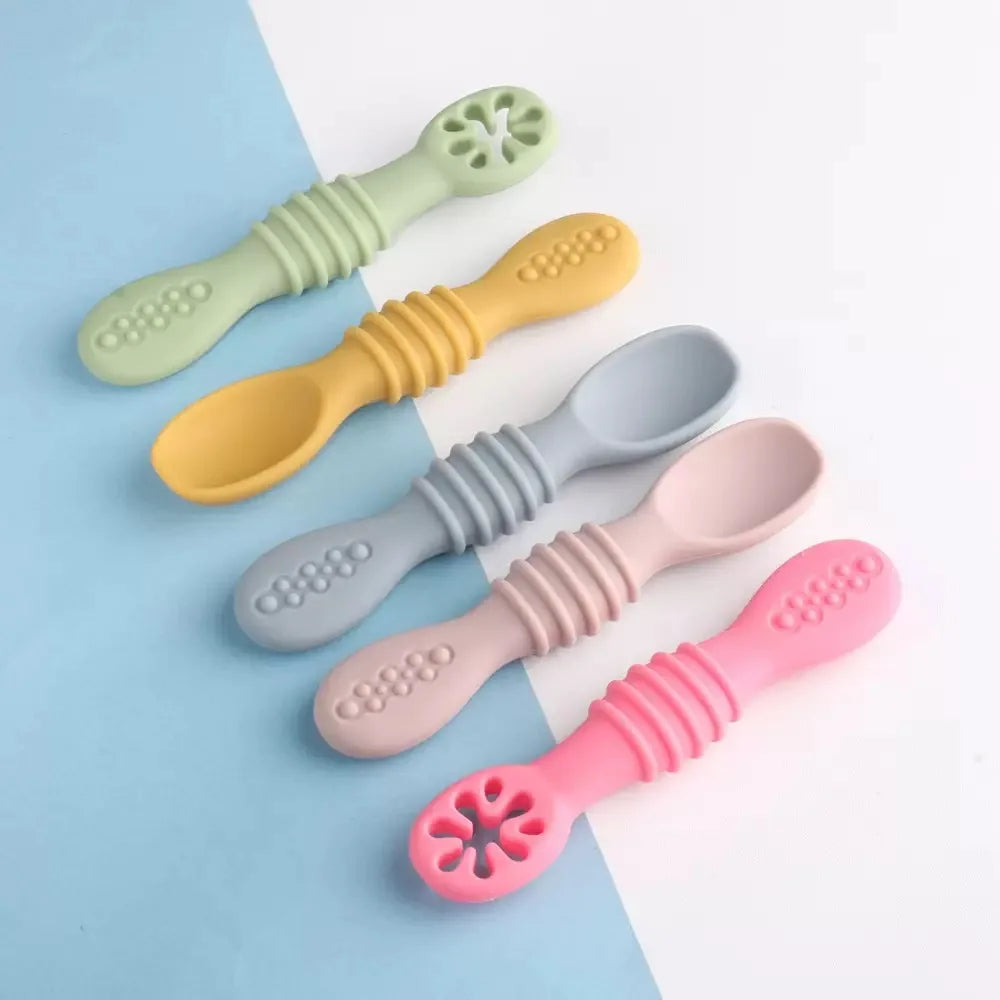 Colorful soft silicone baby spoons for training and feeding, with textured handles and gentle tips.