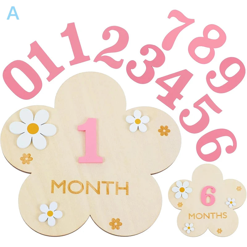 Wooden baby milestone cards with pink numbers, flower shapes, and daisy accents.