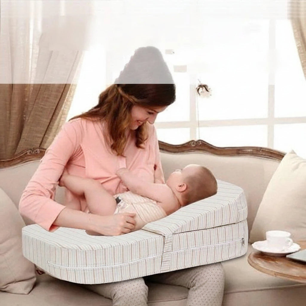 Adjustable striped nursing pillow supporting a baby while a mother smiles.