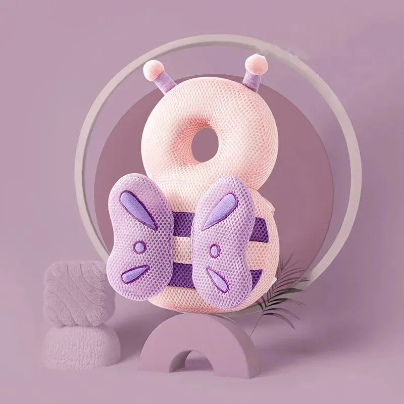 Pink and purple breathable mesh baby head protection pillow, shaped like a bee with antennae and wings.