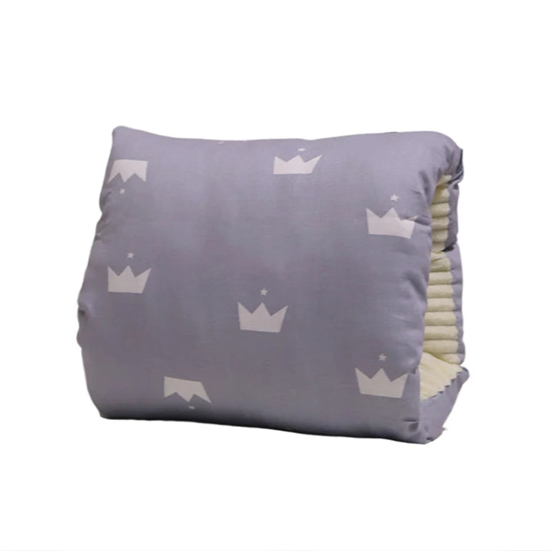 Gray cotton nursing pillow with white crown and star pattern, soft textured inner lining.