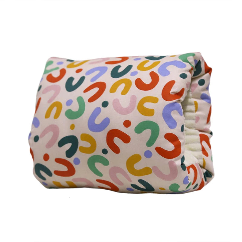 Compact nursing pillow with colorful abstract shapes on a light background, soft cotton and polyester.