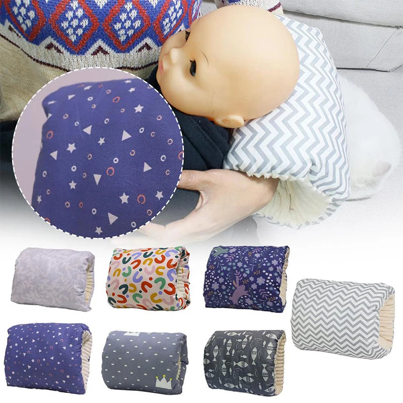 Parent holding a baby doll with a blue star-patterned nursing arm pillow, surrounded by seven other patterned pillows.