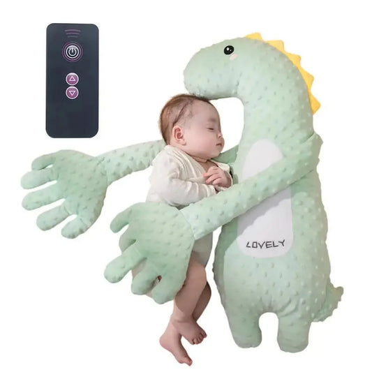 Sleeping baby hugged by a green dinosaur soothing pillow with remote control.