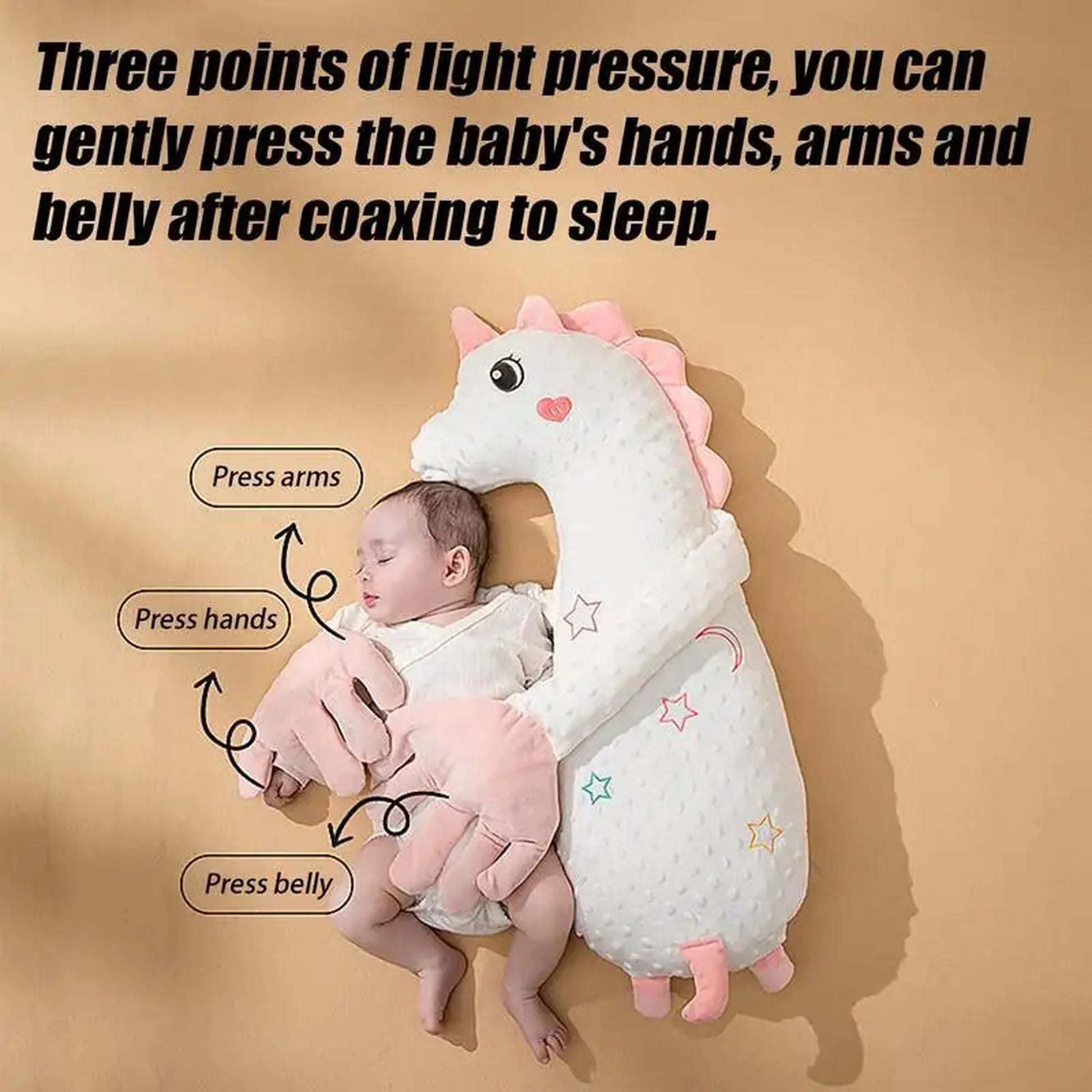 White unicorn baby soothing pillow with pink accents, gently hugging a sleeping infant.