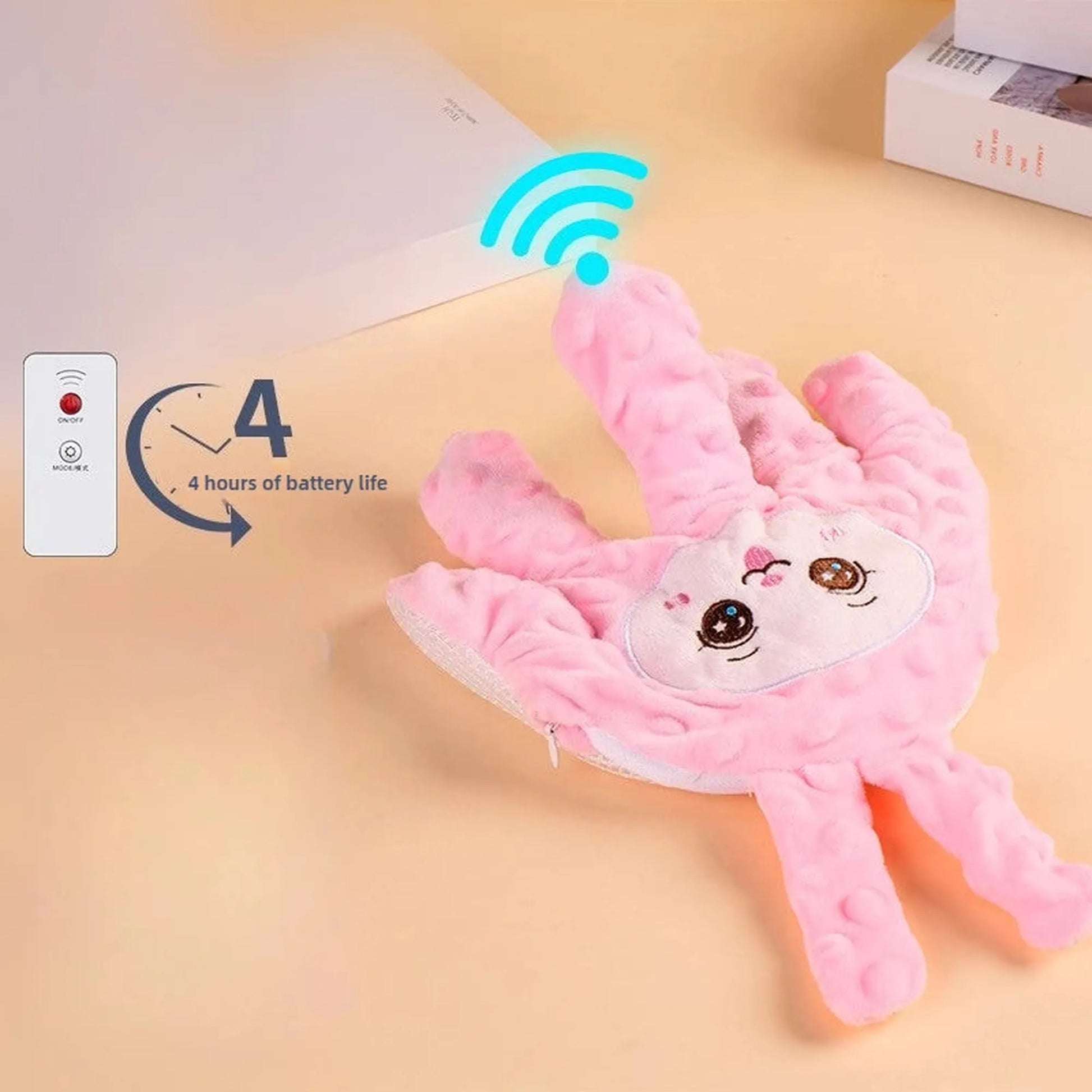 Pink plush baby soothing pillow shaped like a hand with a cute bunny face, remote control, and battery life indicator.