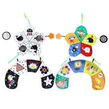 Two baby tummy time pillows: one black and white with high contrast patterns, the other colorful with animal designs.
