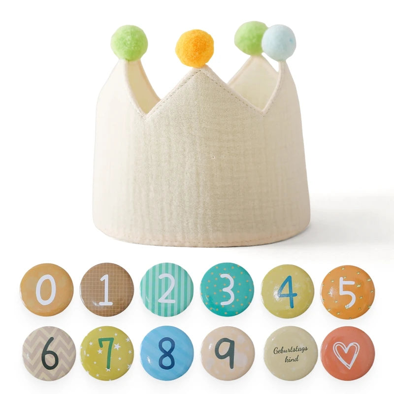 Cream cotton baby birthday crown with colorful pom-poms and interchangeable number pins 0-9.