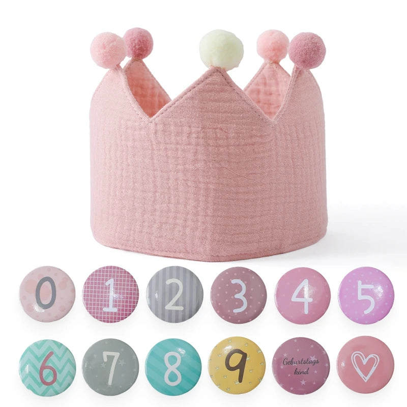 Pink cotton baby birthday crown with pom-poms and interchangeable age number pins 0-9.
