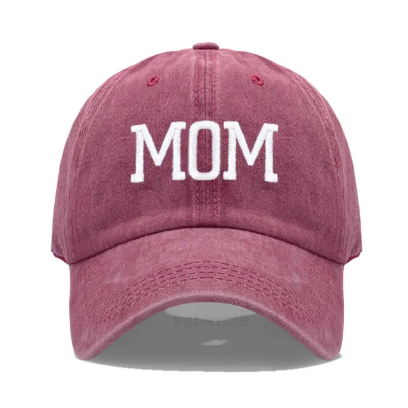 Washed red cotton baseball cap with "MOM" embroidered in white, adjustable for adults.