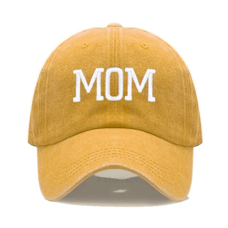 Adjustable mustard yellow cotton baseball cap with "MOM" embroidered in white.