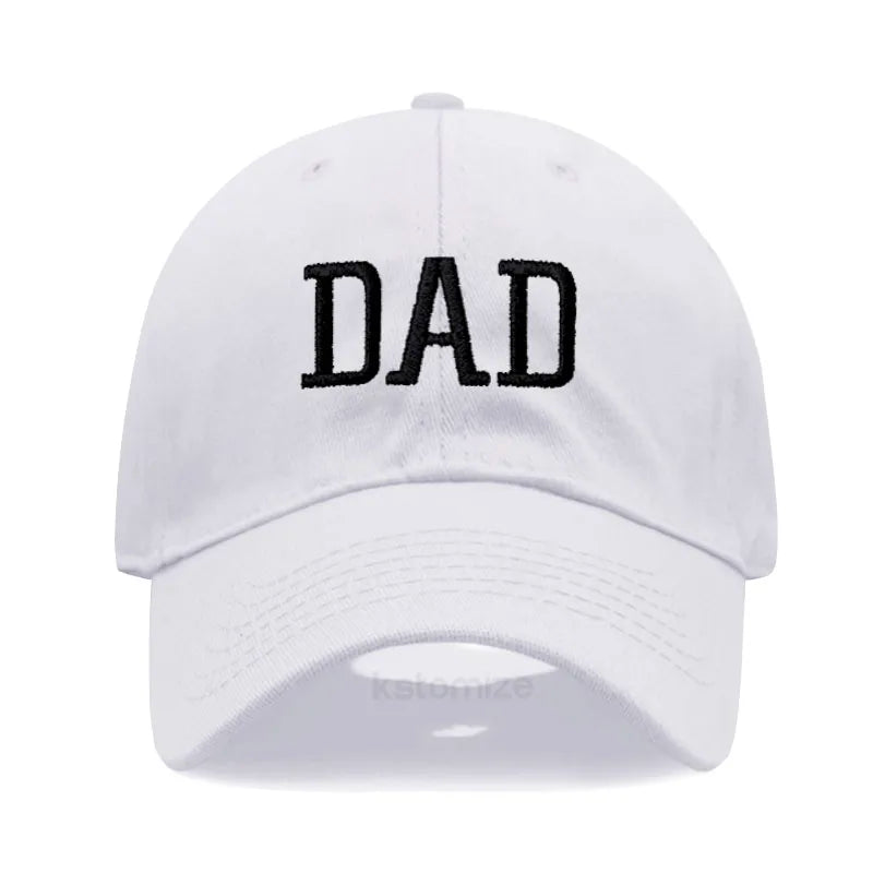 White cotton baseball cap with "DAD" embroidered in black, adjustable for comfort.