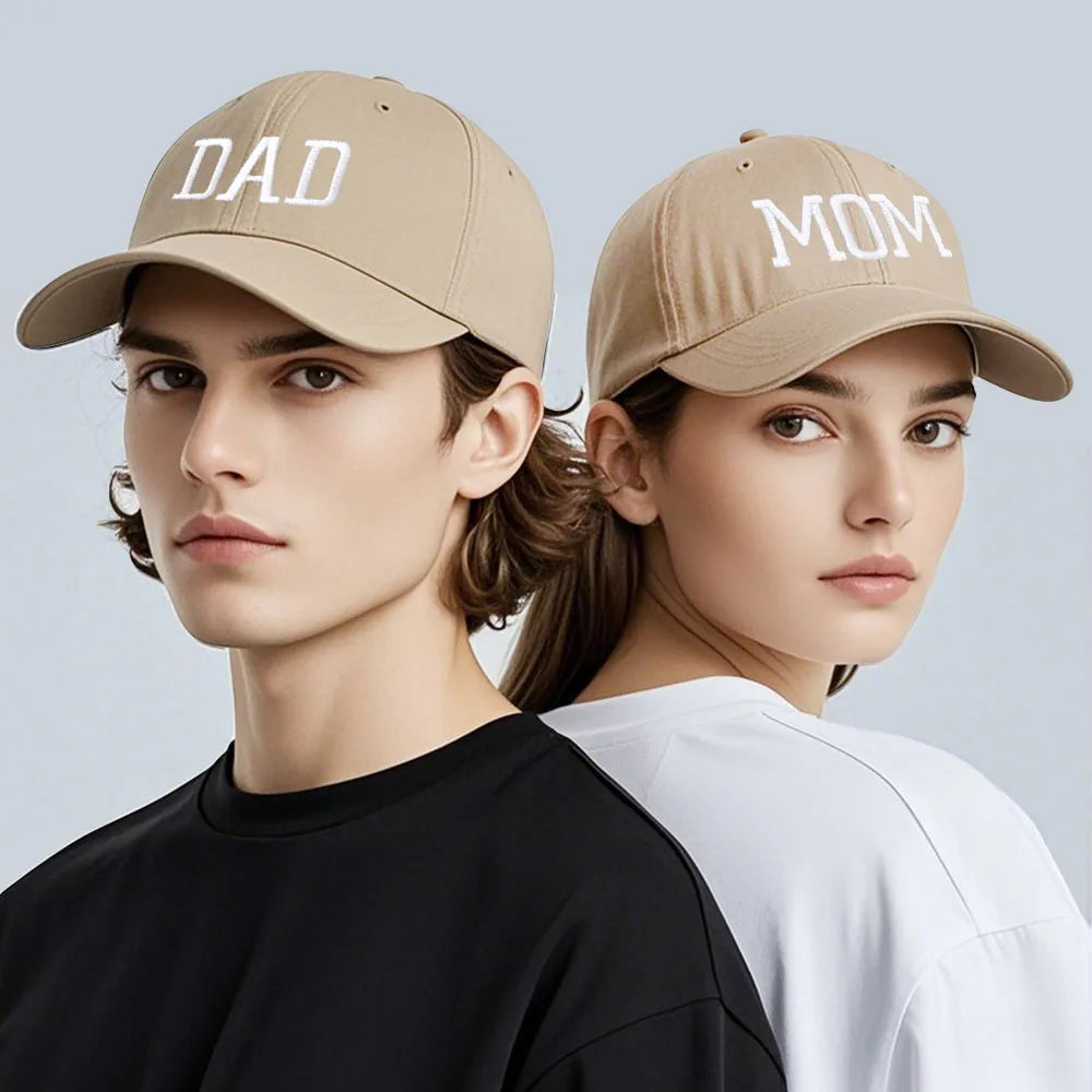 Adjustable beige cotton baseball caps for "DAD" and "MOM" with white embroidery.