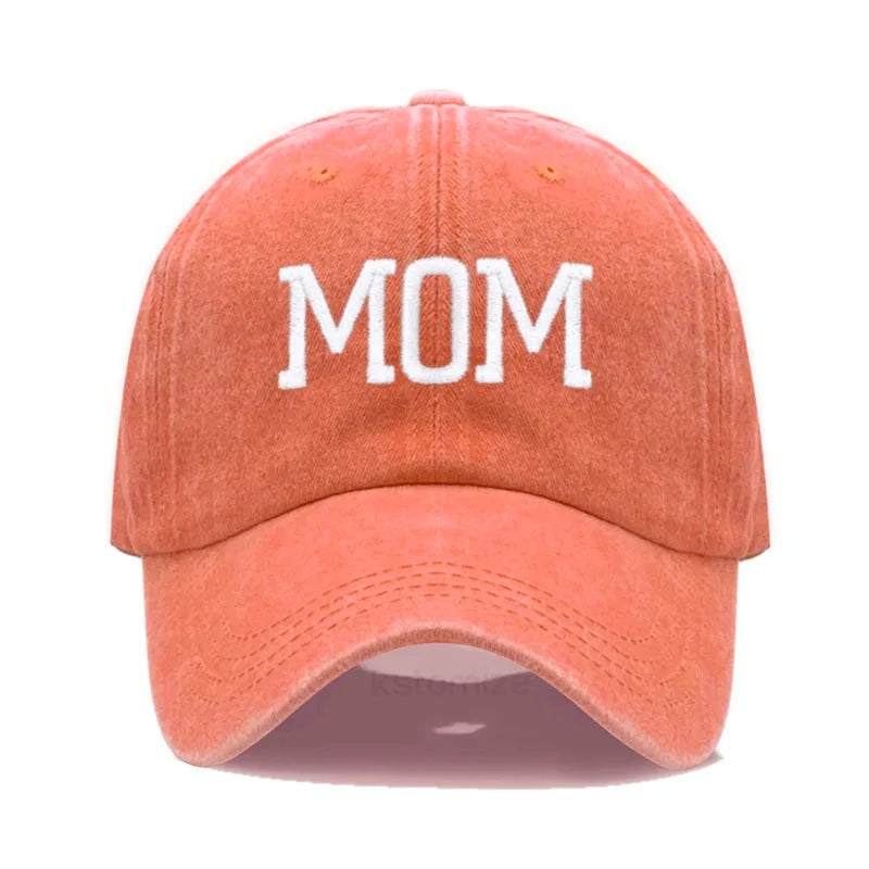 Washed orange cotton baseball cap with "MOM" embroidered in white, adjustable for adults.