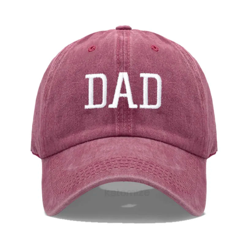 Adjustable red cotton baseball cap with "DAD" embroidered in white.