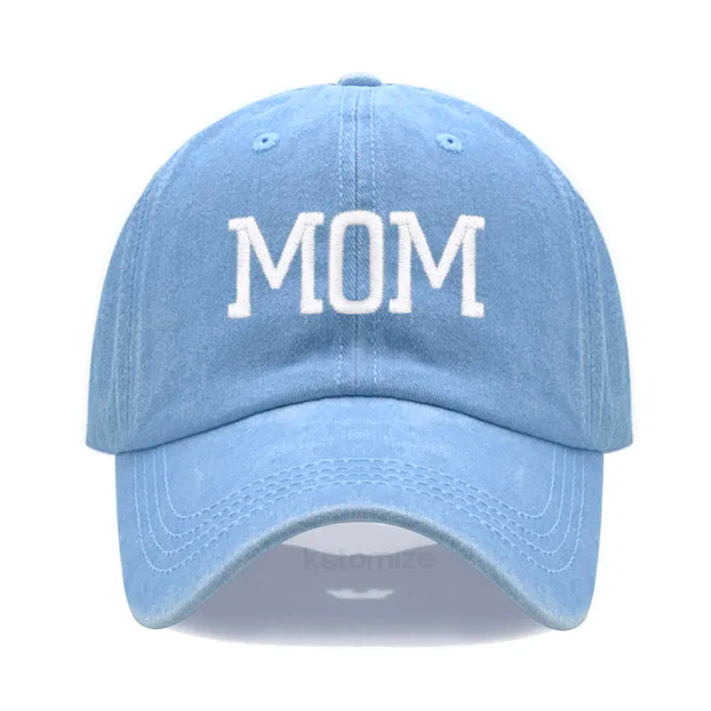 Light blue cotton baseball cap with "MOM" embroidered in white, adjustable for adults.