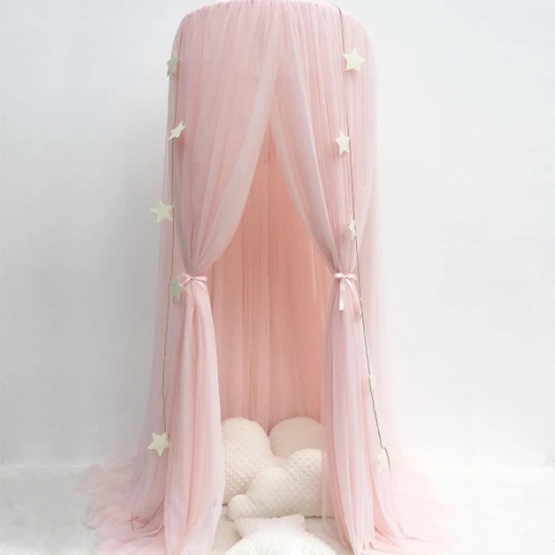 Pink polyester baby bed canopy with white stars, creating a dreamy, protective space.