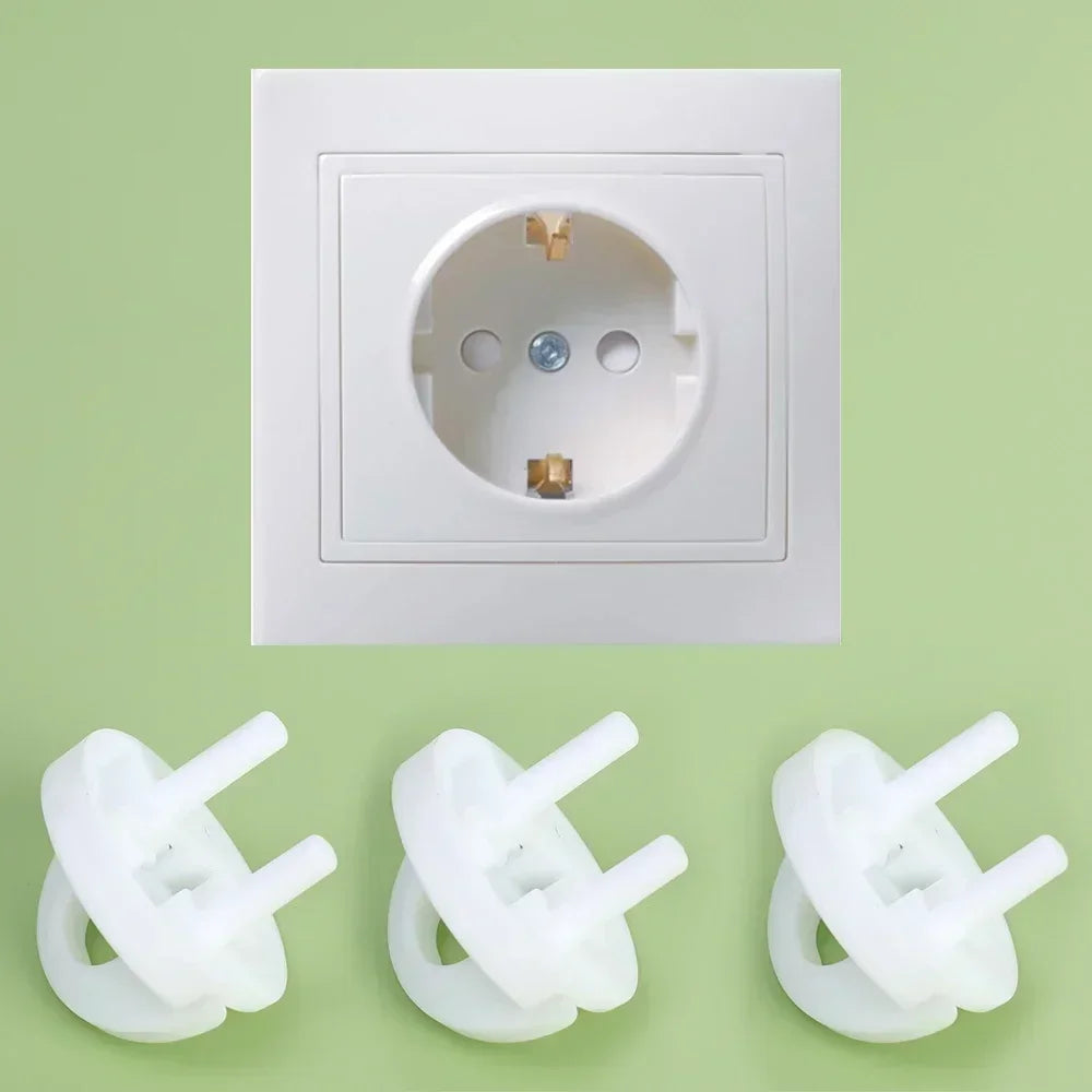 White ABS plastic child safety outlet covers for French standard sockets, shown with a wall socket.
