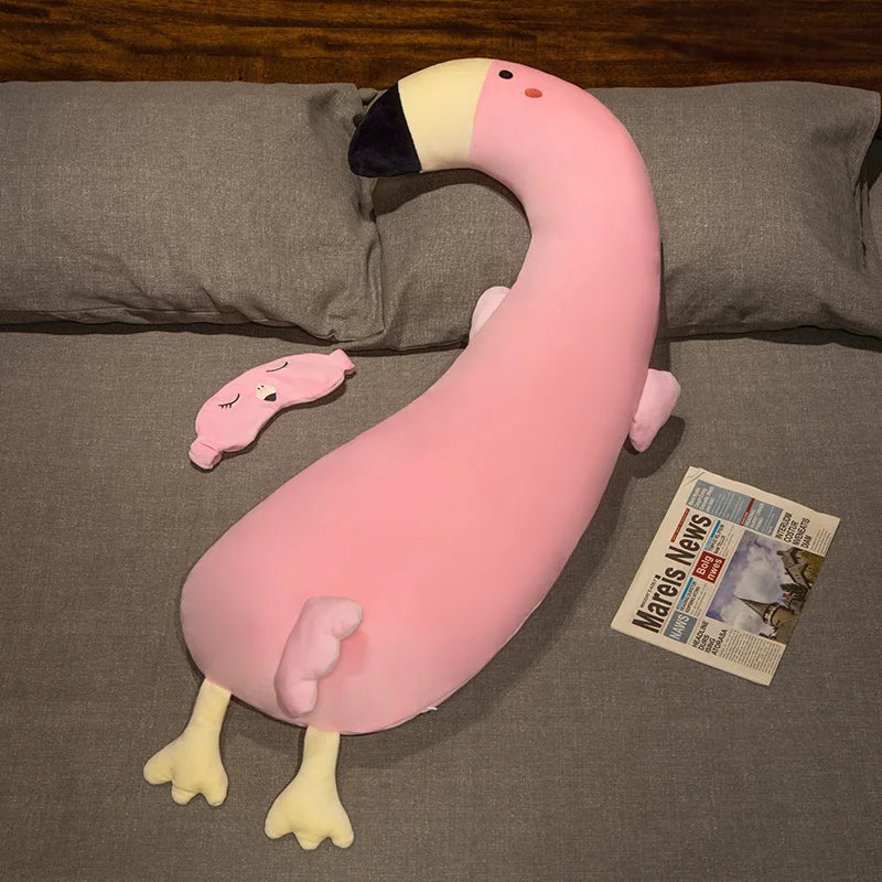 Soft pink flamingo plush pillow, 120cm, with black beak, yellow feet, and a matching sleep mask.