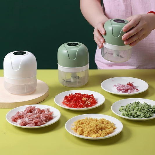 White and green mini electric food choppers with various chopped ingredients.
