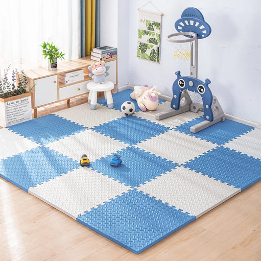 Blue and white checkered foam puzzle play mat for babies, with toys in a bright room.