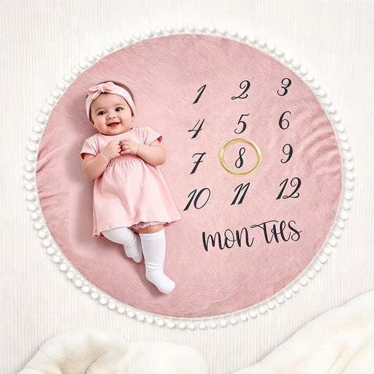 Pink flannel baby milestone blanket, 100x100cm, with monthly numbers and pom-pom trim.