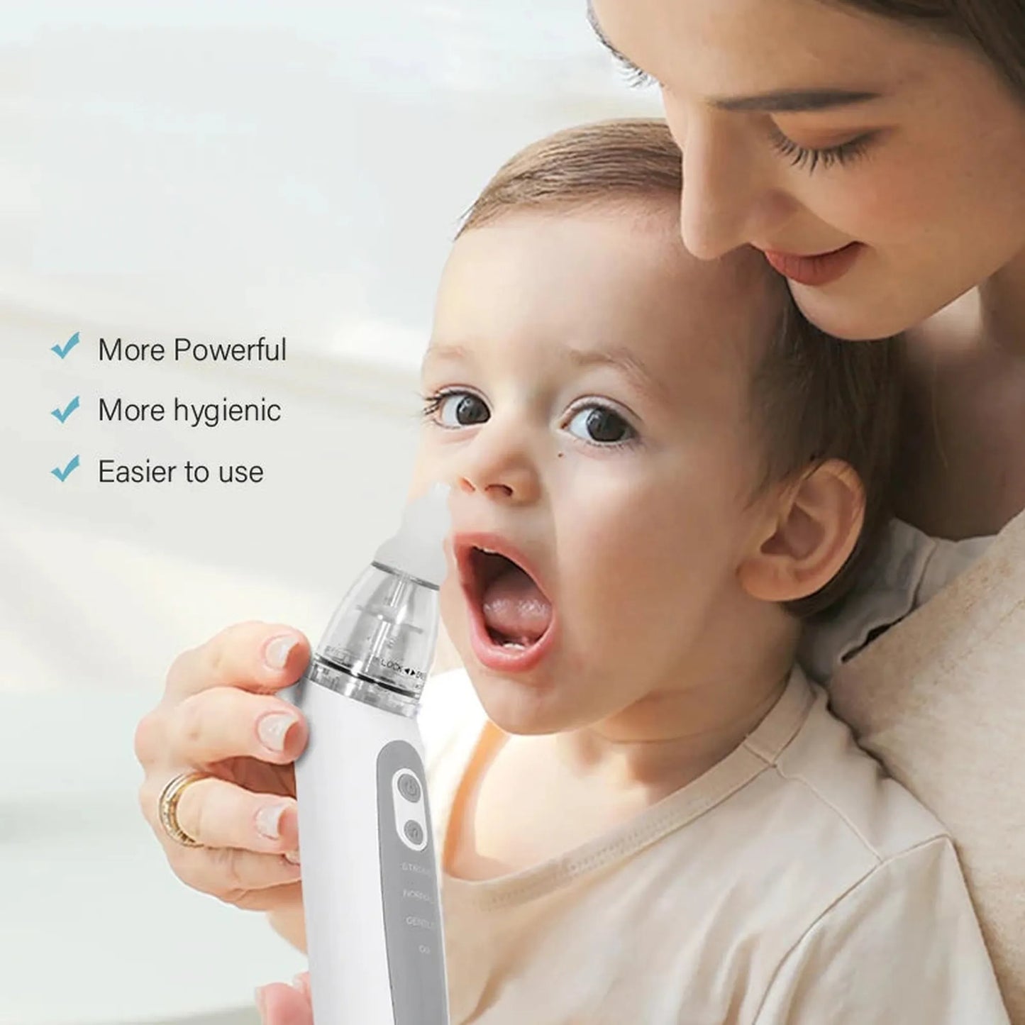 White electric baby nasal aspirator with a soft silicone tip, held by a woman for a baby.