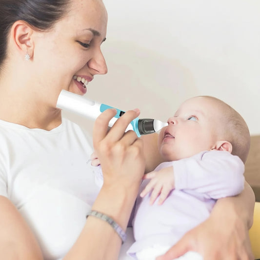 Mother using a white and blue electric nasal aspirator with a soft silicone tip on a baby.