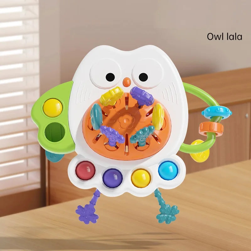 Montessori silicone owl sensory pull string toy with colorful pop-its and textured ropes.