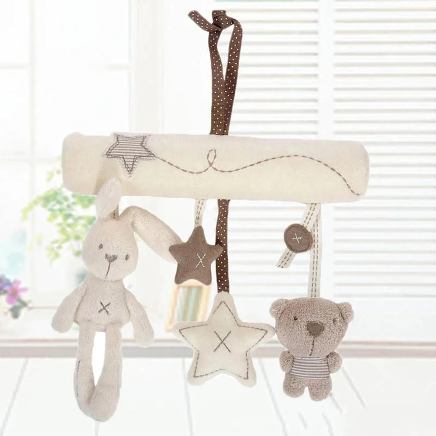 Soft plush baby rattle toy with hanging bunny, bear, and stars in cream and brown.