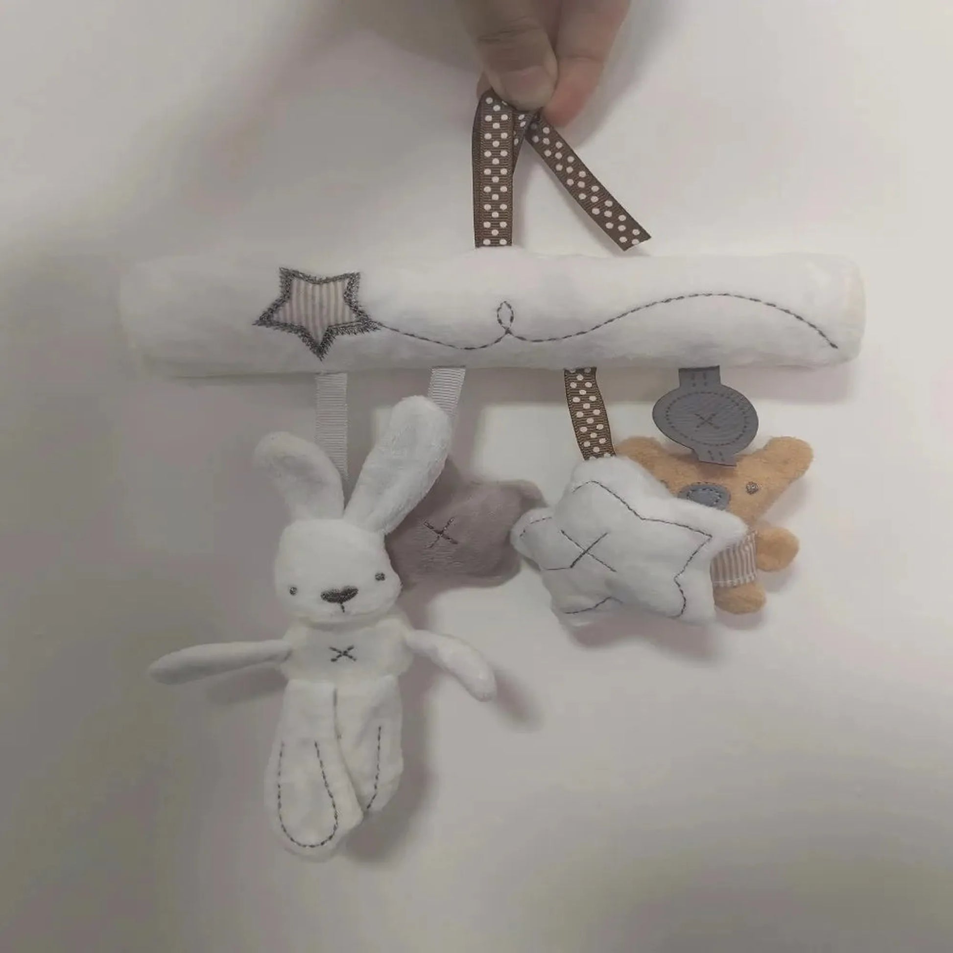 Soft white plush baby rattle mobile with hanging bunny, star, and bear toys.