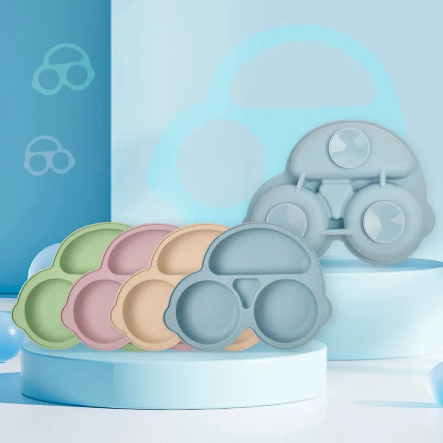 Car-shaped silicone suction plates in green, pink, orange, and blue, with a grey plate showing the vacuum base.