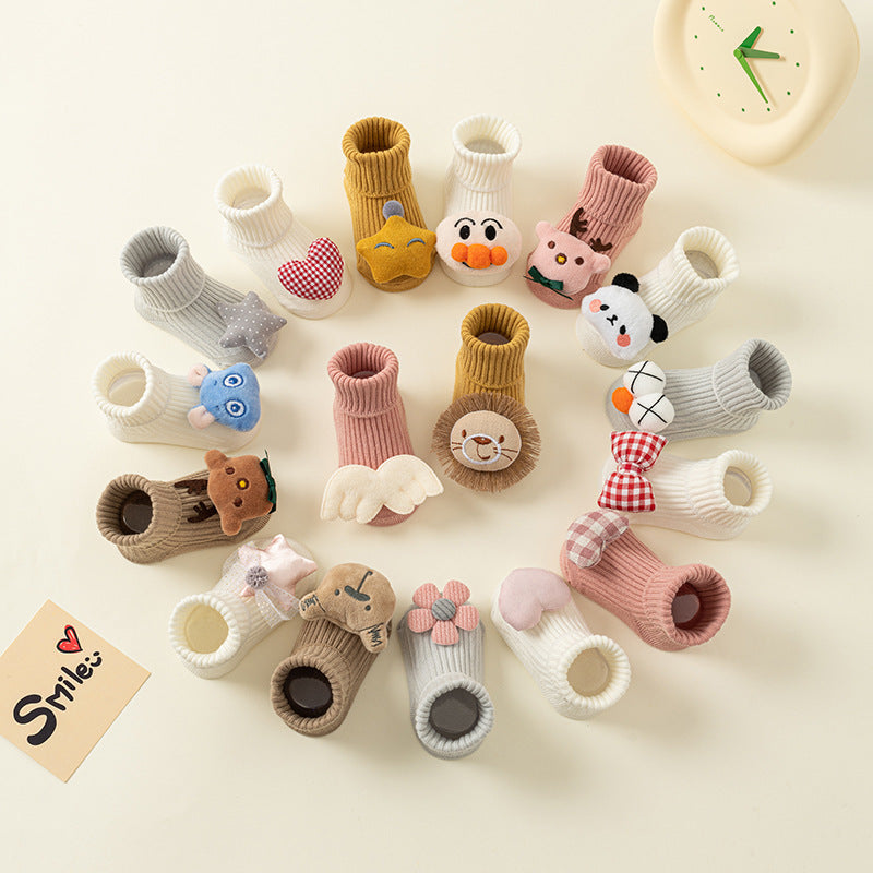 Assorted cotton baby socks with cute animal and character designs, anti-slip soles, in various colors.