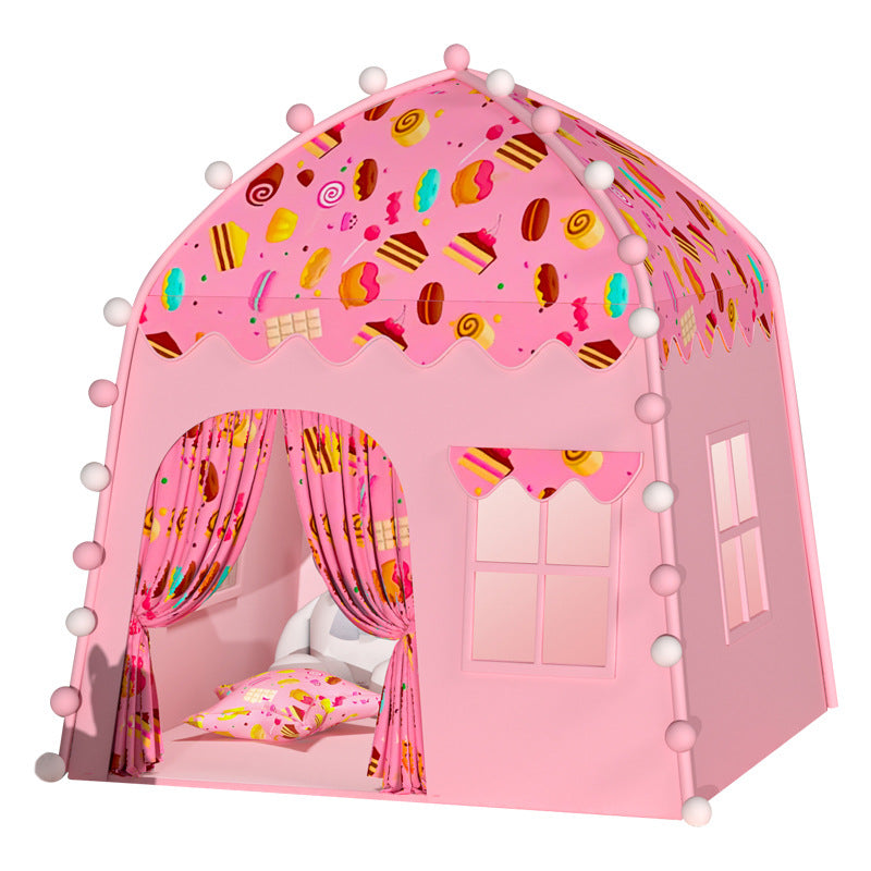 Pink oxford fabric kids' play castle tent with dessert print roof, curtains, windows, and decorative pom-poms.