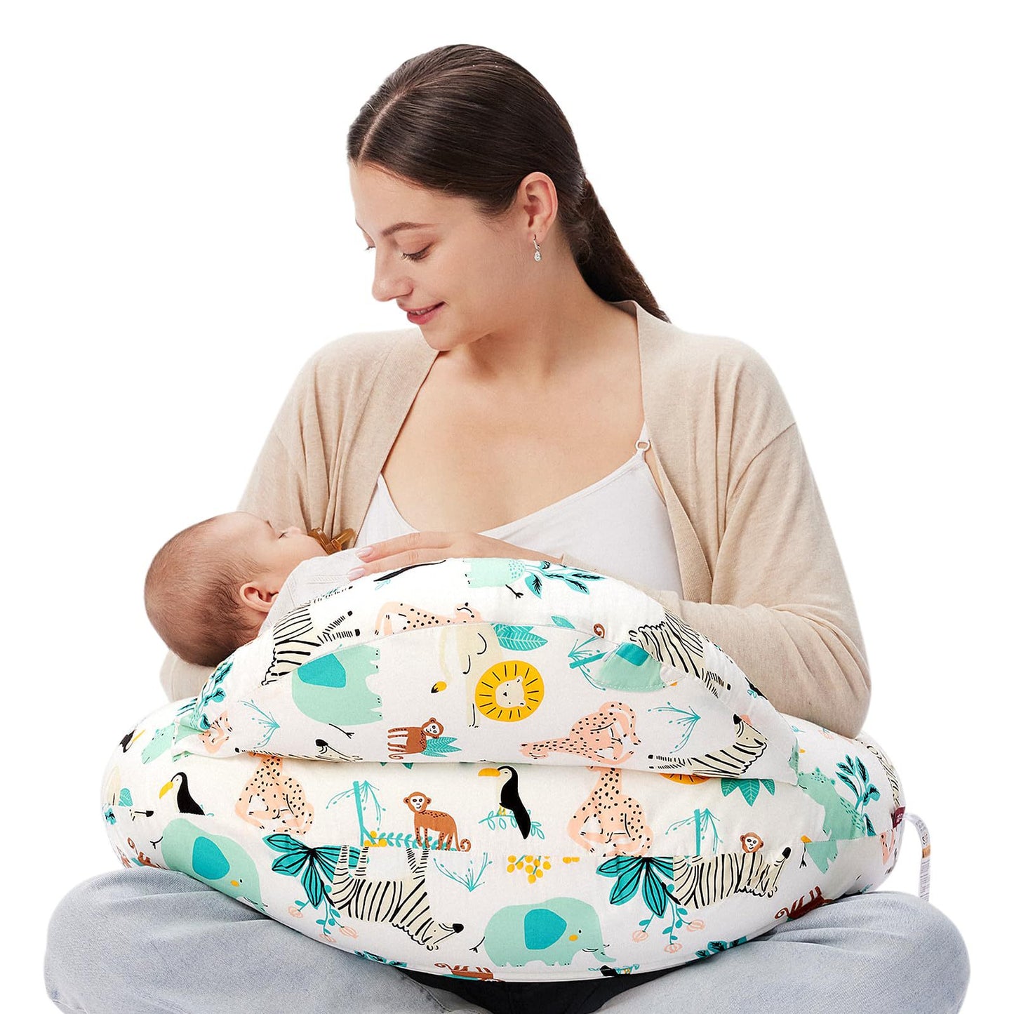 Woman breastfeeding baby using a white multi-functional nursing pillow with colorful jungle animal print.
